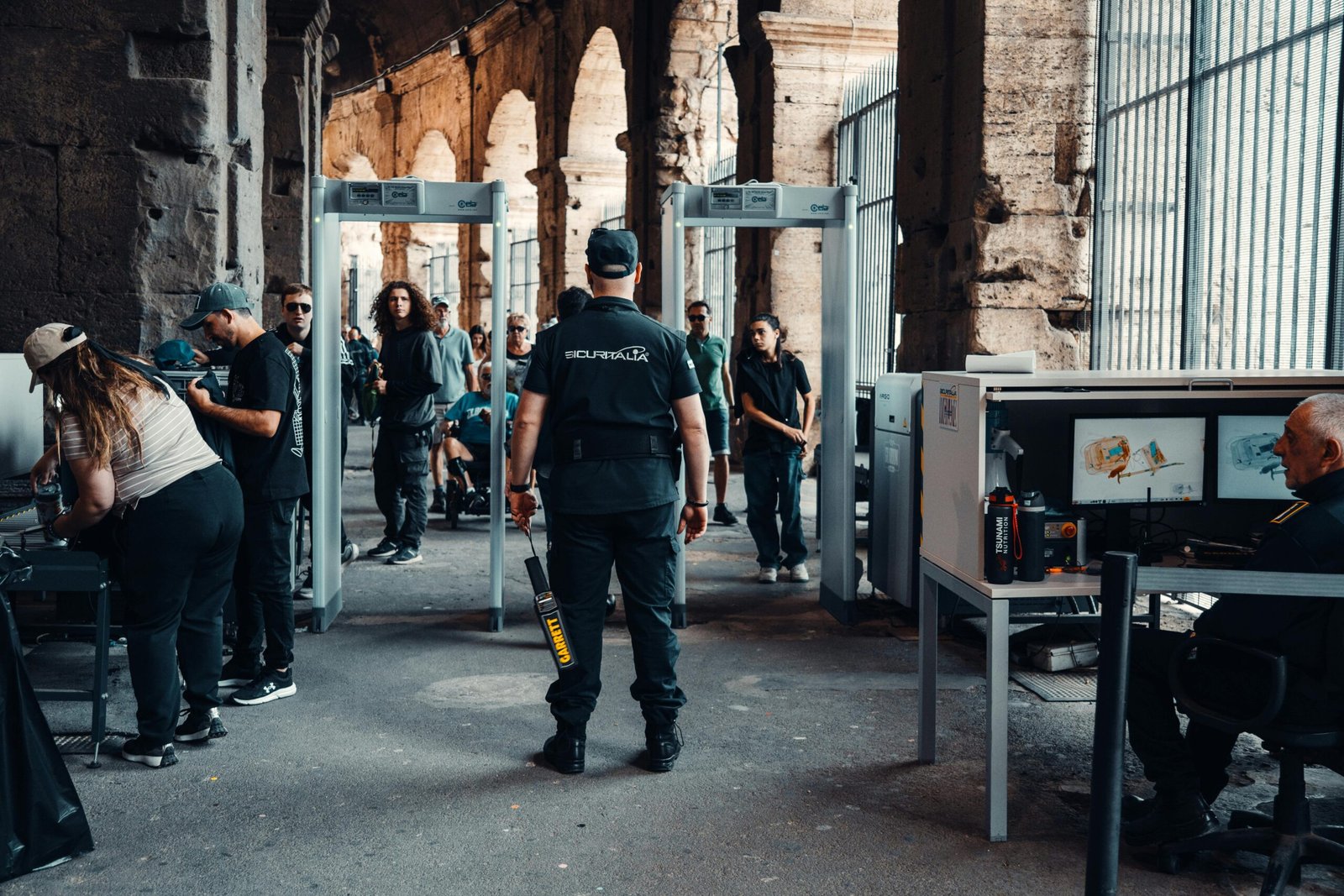 Home Security checkpoint with guards at a bustling historical site entrance.